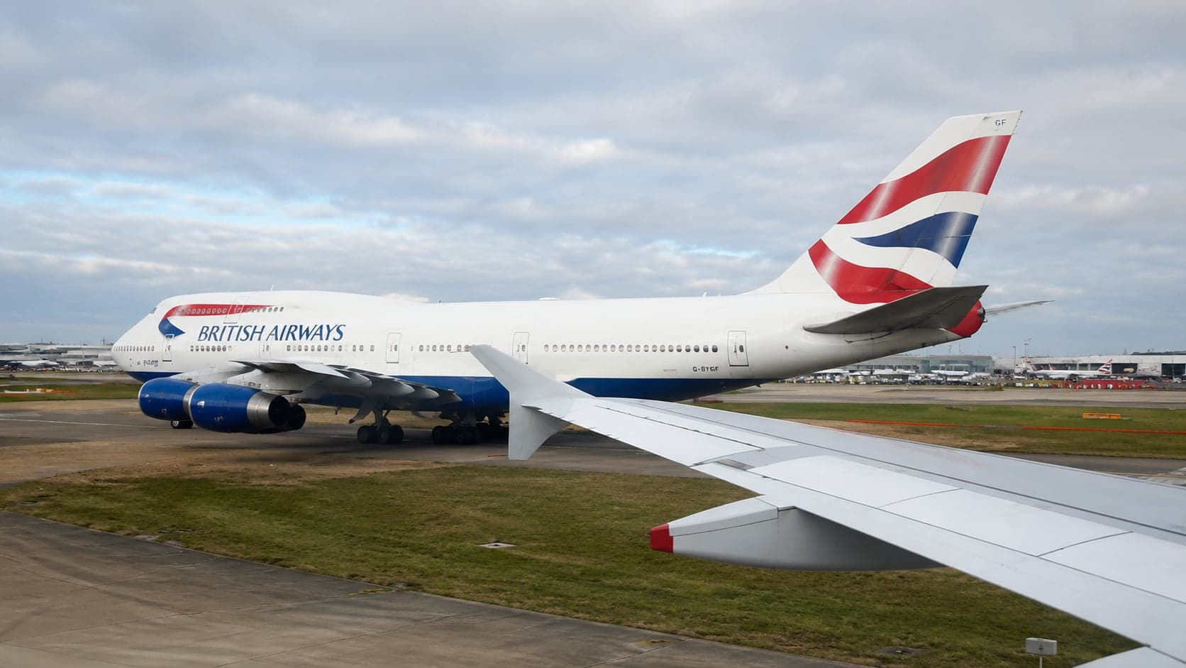 British Airways Boeing 747 on the Heathrow apron, viewed from the wing of another aircraft